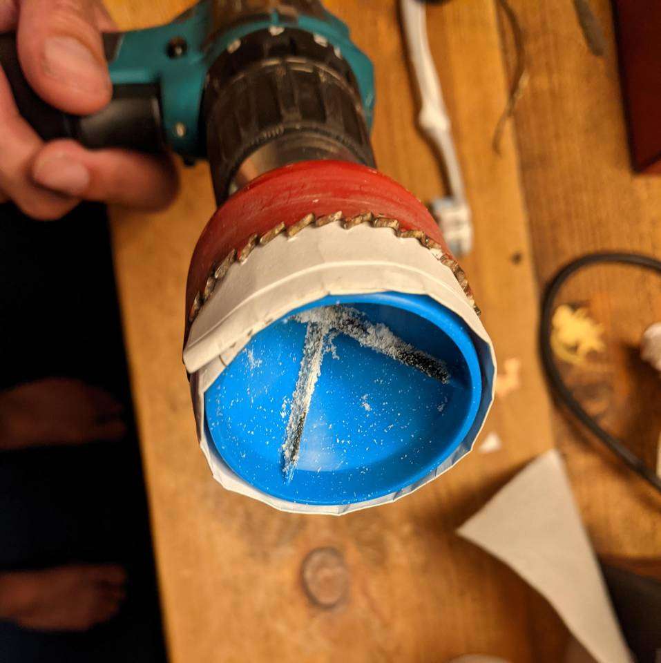 Pipe reamer inside a holesaw, padded with paper